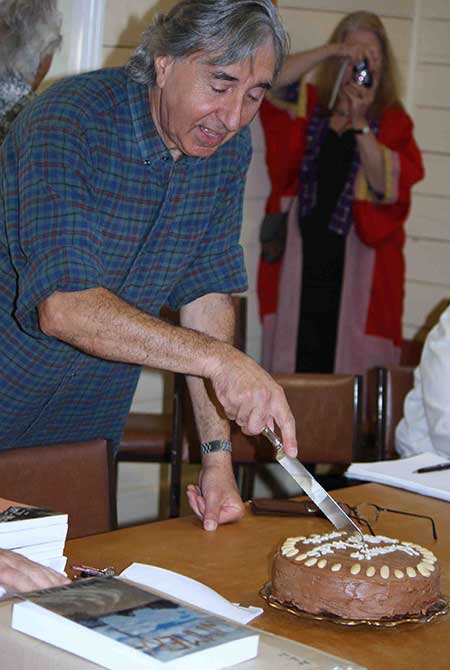 Homer Rieth cutting the cake at the Minyip launch of 150 Motets
